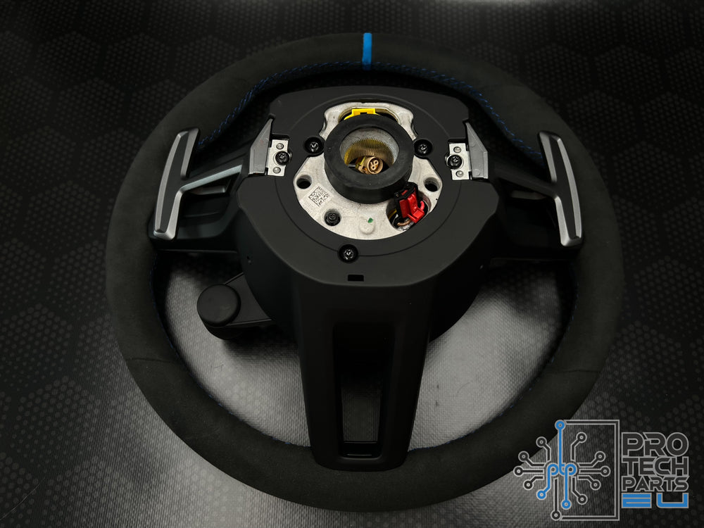 
                  
                    a black steering wheel
                  
                